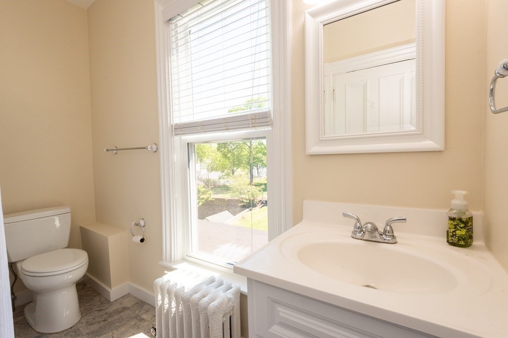 30 Chestnut Street Stoneham, MA 02180 - Photo 36 of 41 a bathroom with a sink a toilet and a window
