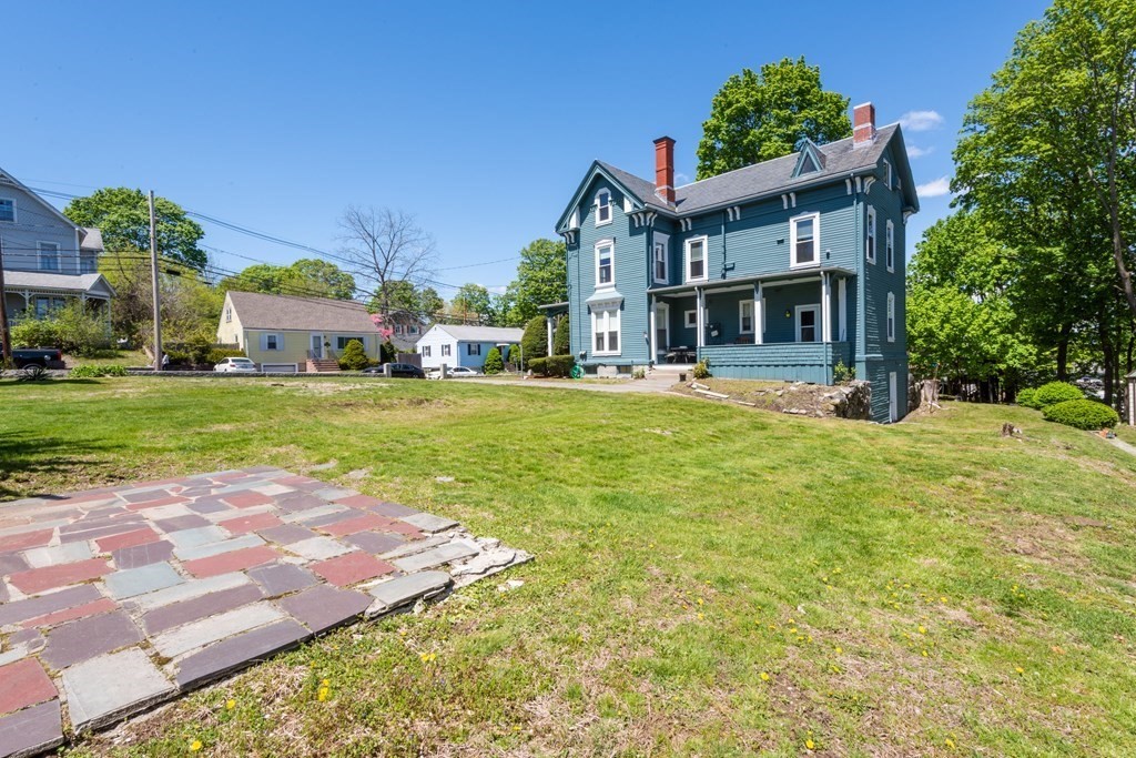 30 Chestnut Street Stoneham, MA 02180 - Photo 5 of 41 a view of a house with a big yard and large trees