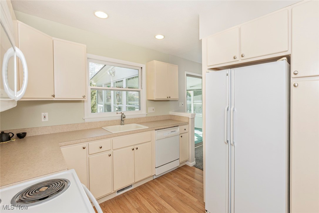 1691 Harwich Road Lyndhurst, OH 44124 - Photo 6 of 45 Kitchen with white appliances, light countertops, light wood-type flooring, and recessed lighting