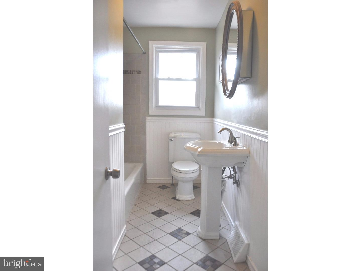 591 Farnum Road Media, PA 19063 - Photo 19 of 21 a bathroom with a toilet a sink and mirror