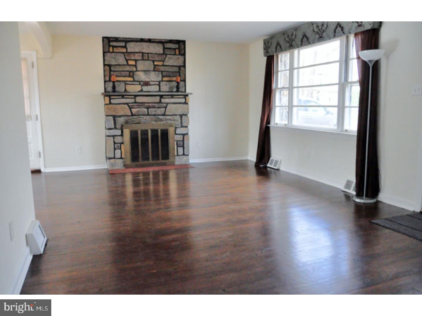 591 Farnum Road Media, PA 19063 - Photo 4 of 21 a view of a livingroom with wooden floor a fireplace and window