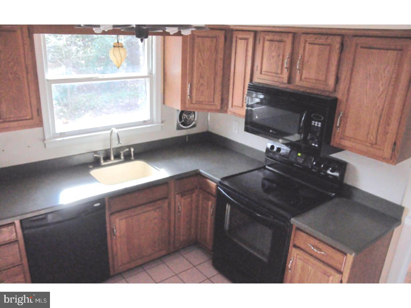 591 Farnum Road Media, PA 19063 - Photo 8 of 21 a kitchen with a sink stove and cabinets