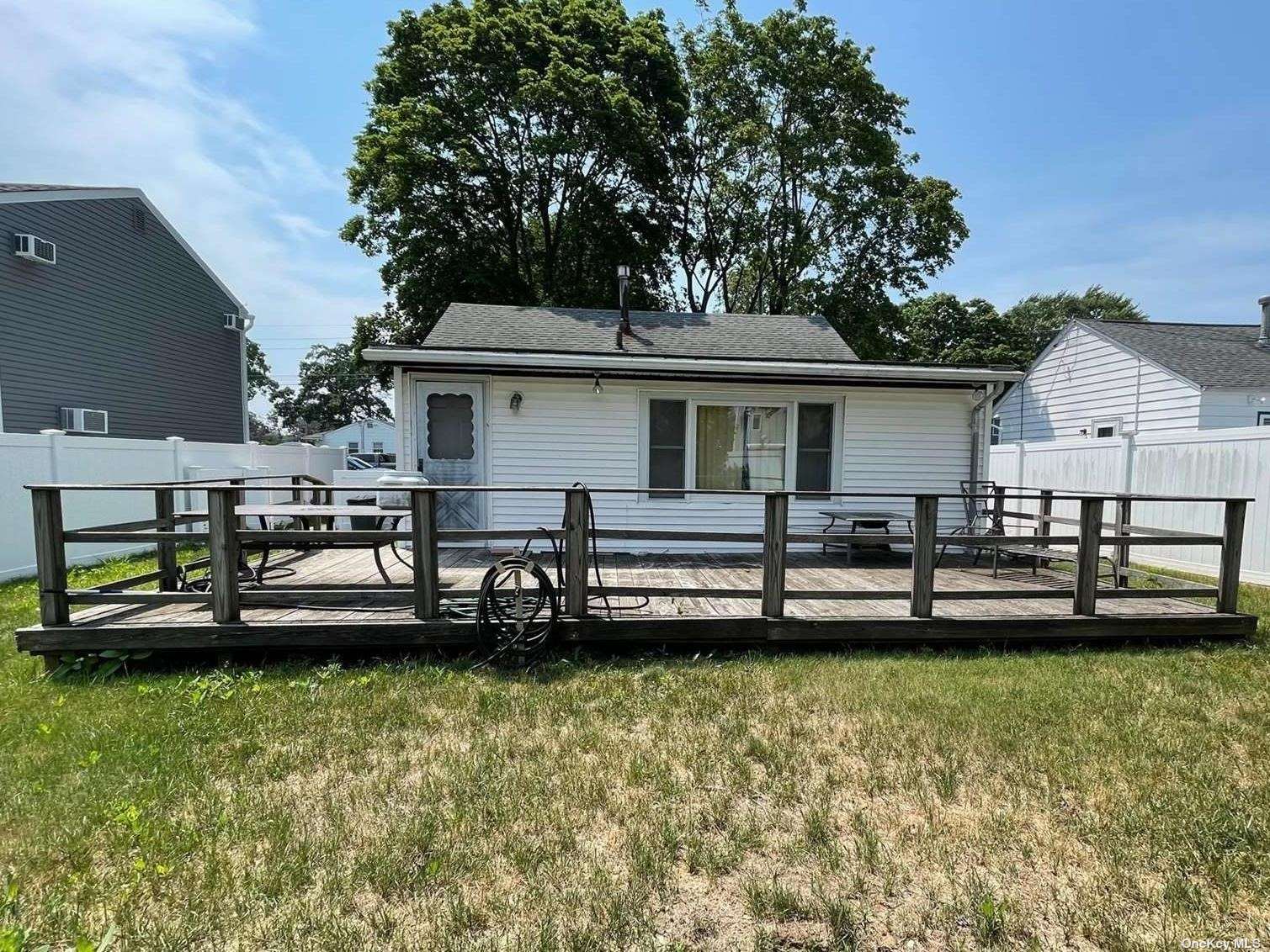 a front view of a house with a yard table and chairs