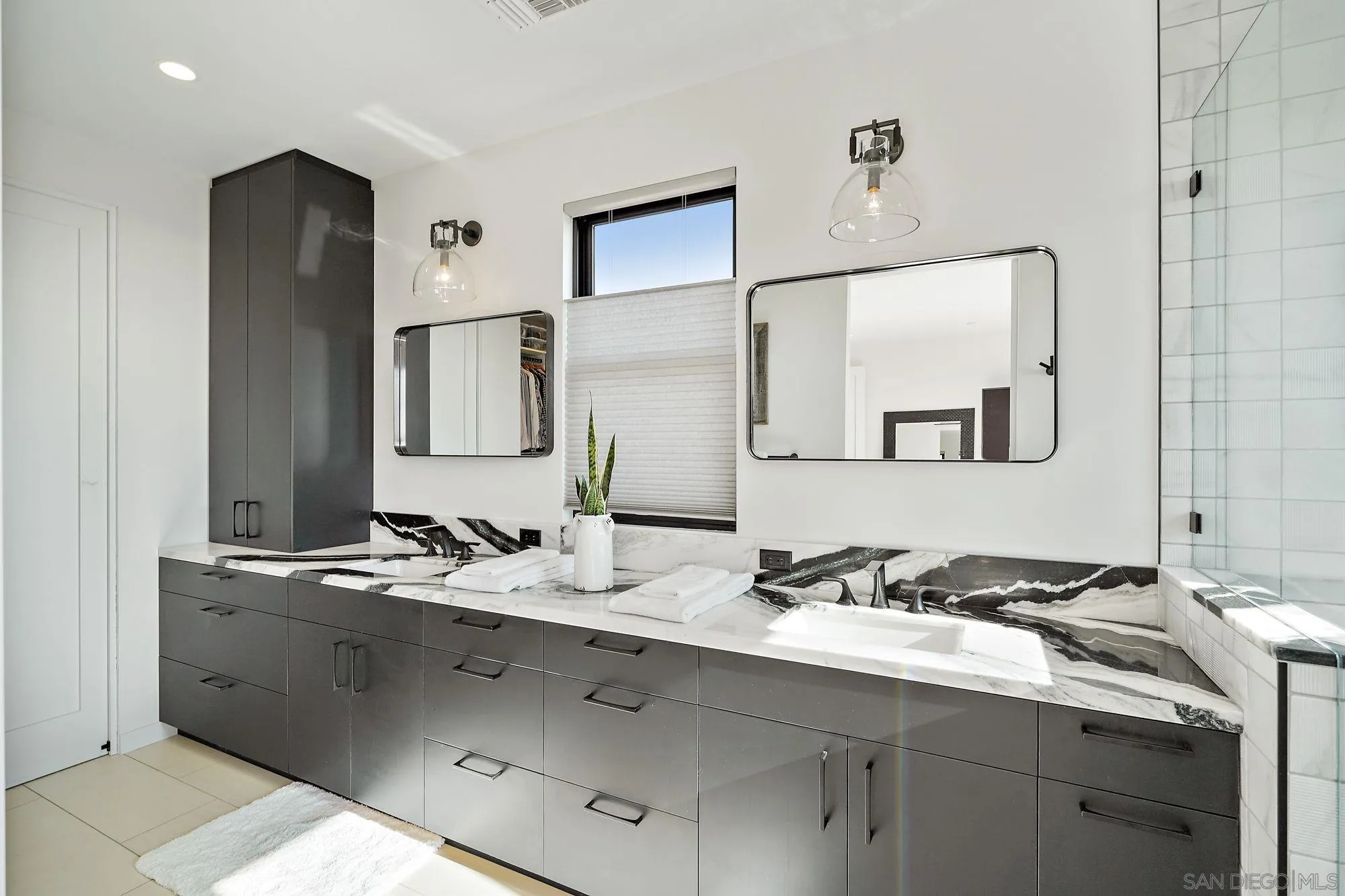 1604 Legaye Drive Encinitas, CA 92007 - Photo 13 of 43 a bathroom with a double vanity sink and a mirror