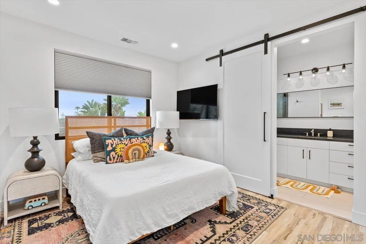 1604 Legaye Drive Encinitas, CA 92007 - Photo 26 of 43 a bedroom with a bed and a flat tv screen on the dresser