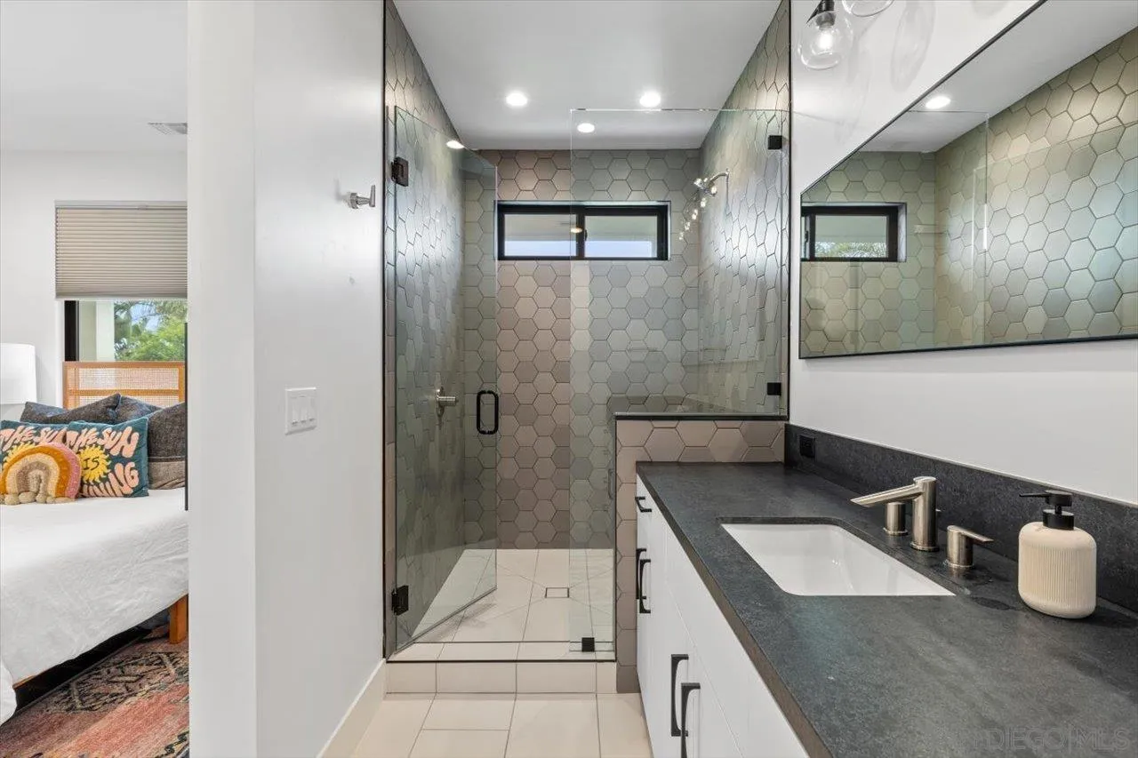 1604 Legaye Drive Encinitas, CA 92007 - Photo 29 of 43 a bathroom with a tub sink and mirror