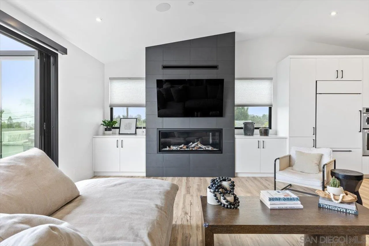 1604 Legaye Drive Encinitas, CA 92007 - Photo 3 of 43 a living room with furniture a flat screen tv and a fireplace