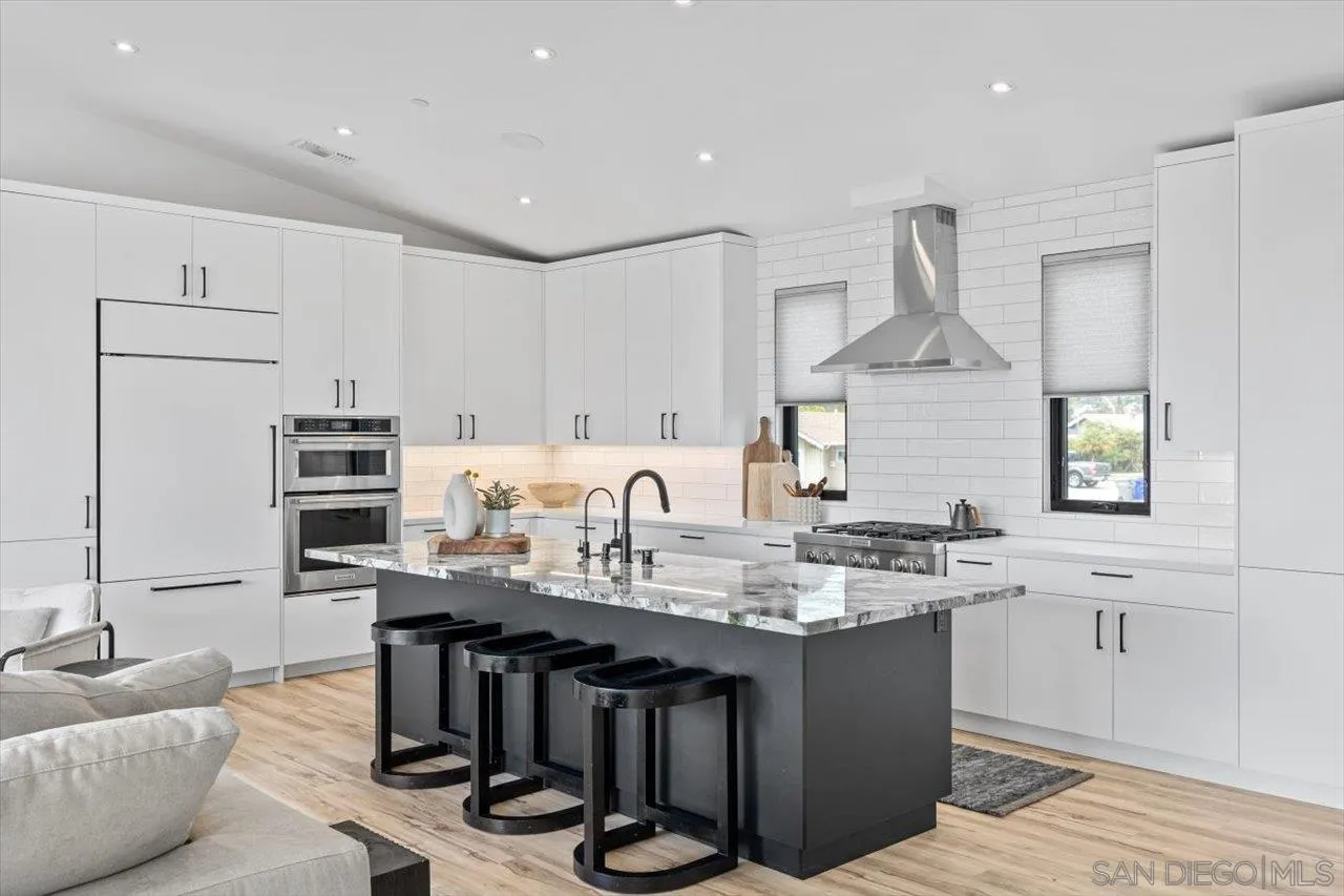 1604 Legaye Drive Encinitas, CA 92007 - Photo 5 of 43 a kitchen with kitchen island granite countertop a sink cabinets and stainless steel appliances