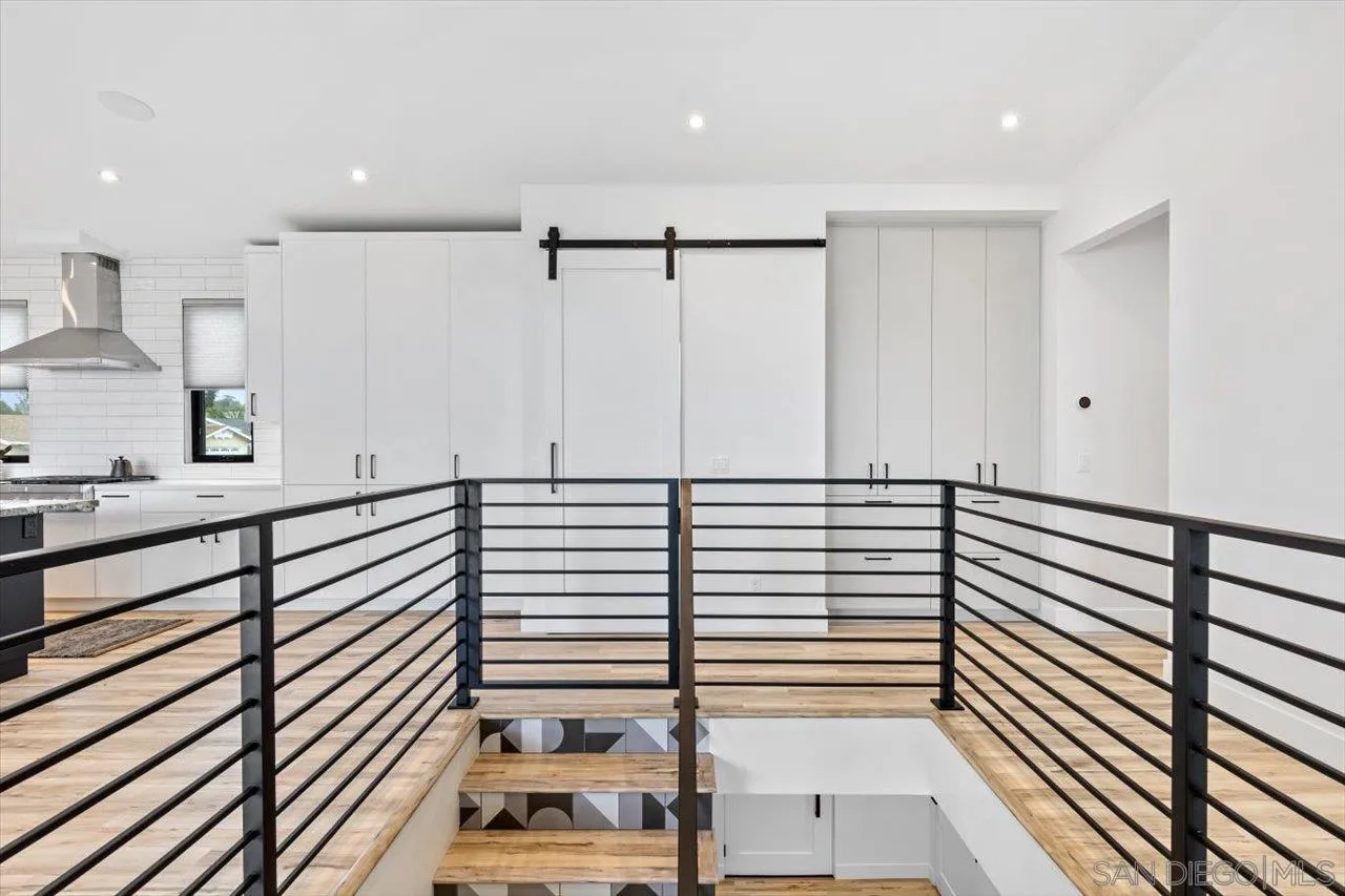 1604 Legaye Drive Encinitas, CA 92007 - Photo 9 of 43 a view of a kitchen with kitchen island a large window a sink and a counter top space