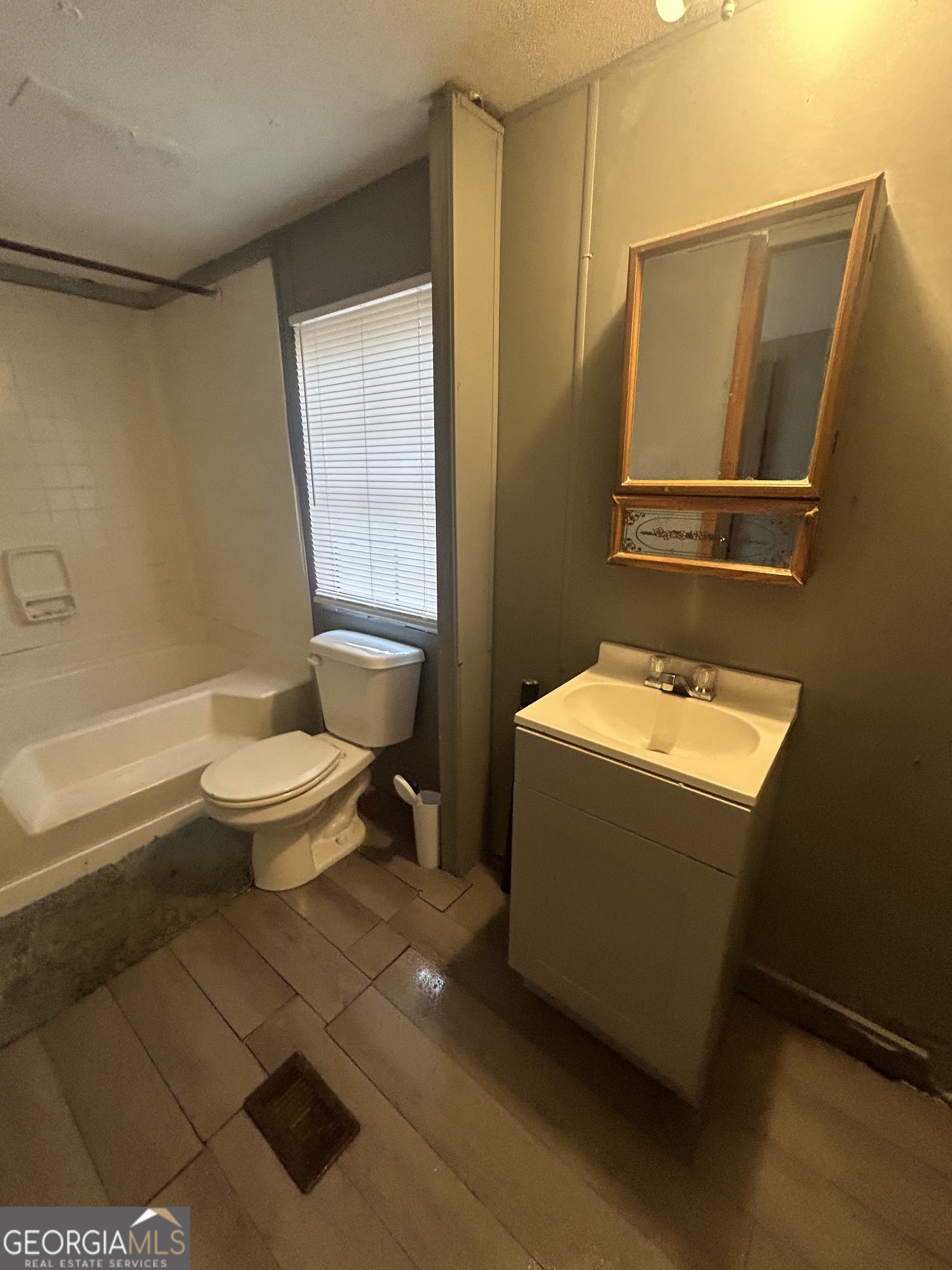 264 Lakeview Drive Locust Grove, GA 30248 - Photo 5 of 13 a bathroom with a sink toilet and shower