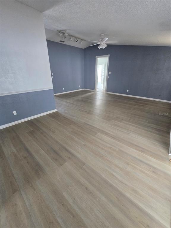 12825 Tallowood Drive Riverview, FL 33579 - Photo 2 of 10 a view of an empty room with wooden floor