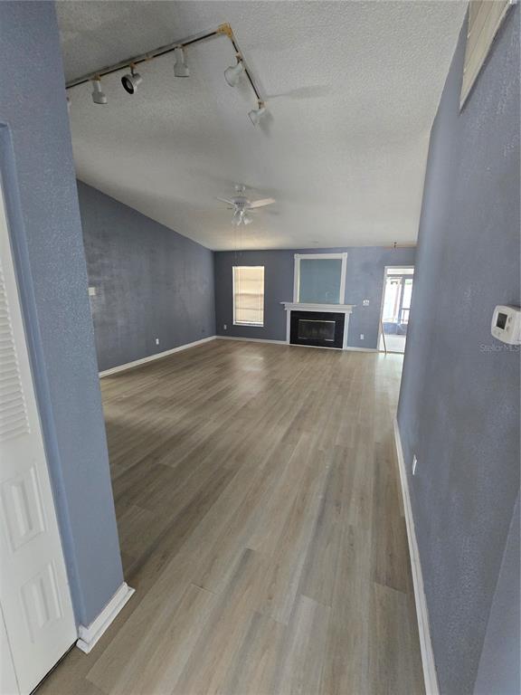 12825 Tallowood Drive Riverview, FL 33579 - Photo 3 of 10 a view of empty room with wooden floor and fireplace