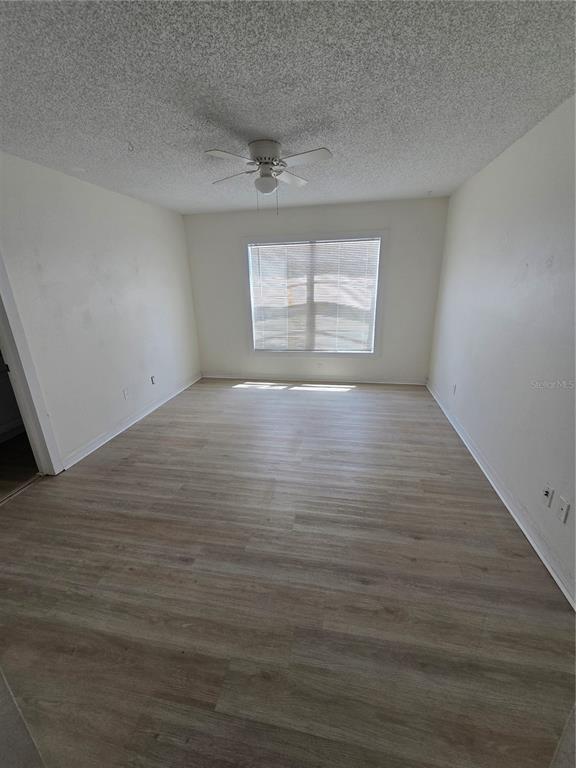 12825 Tallowood Drive Riverview, FL 33579 - Photo 5 of 10 wooden floor in an empty room with a window