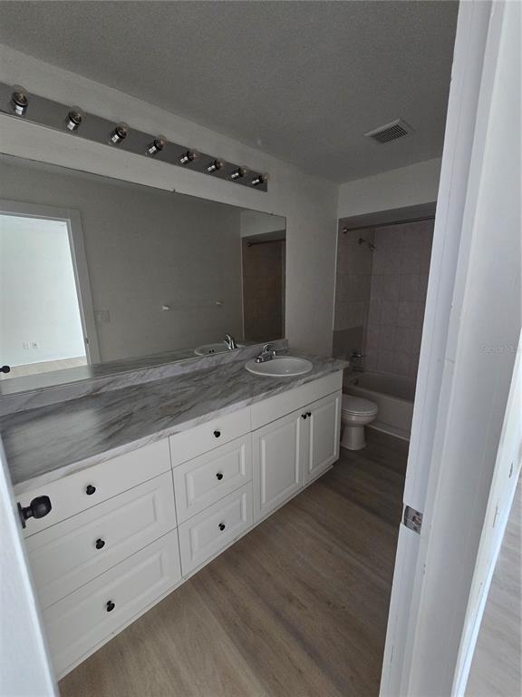 12825 Tallowood Drive Riverview, FL 33579 - Photo 6 of 10 a bathroom with a granite countertop sink mirror and toilet