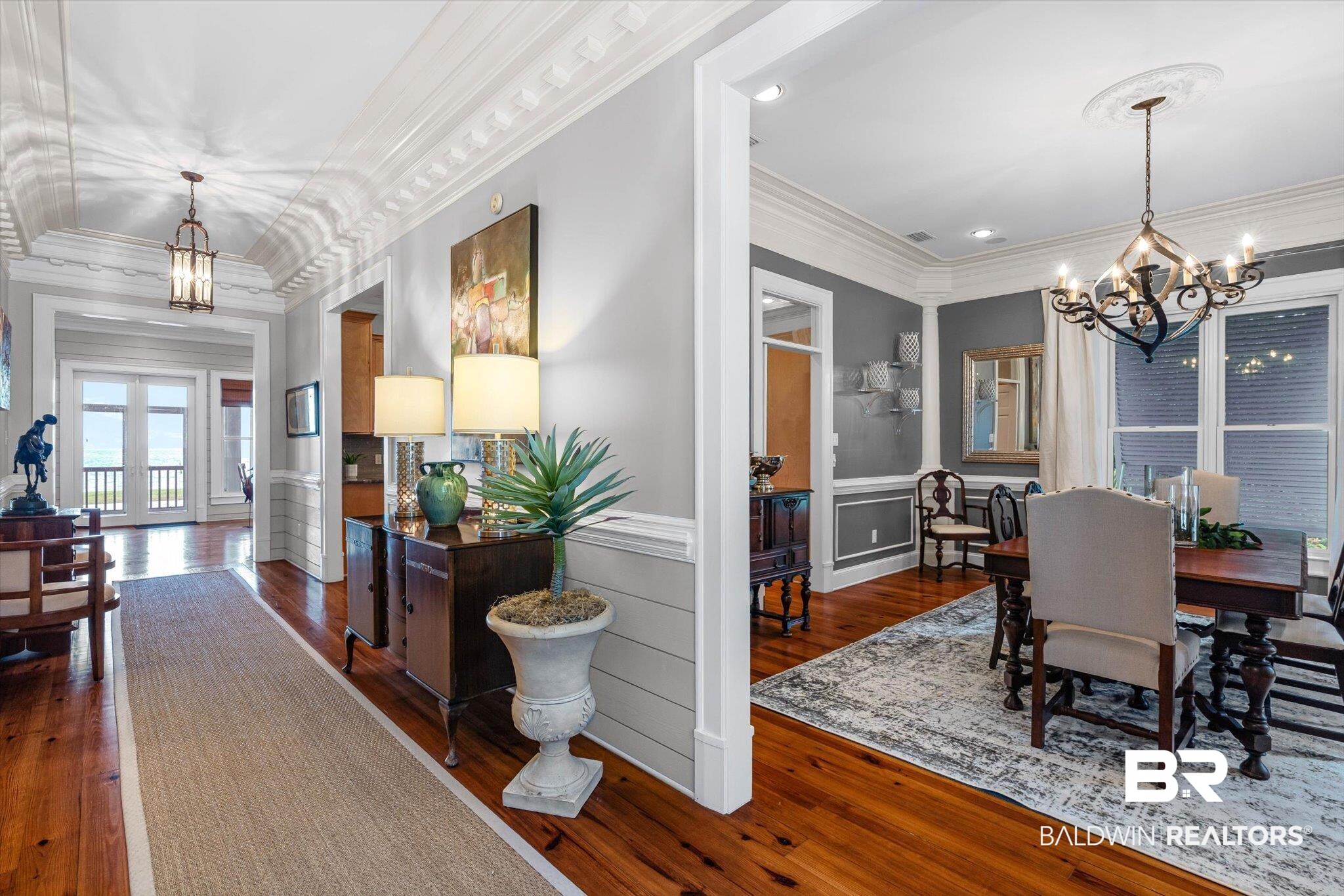 7015 Bay Road Mobile, AL 36605 - Photo 3 of 53 Dining room featuring a chandelier, ornamental molding, dark wood-style flooring, french doors, and a wainscoted wall