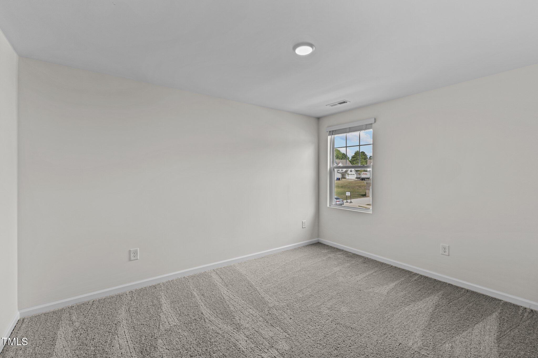 867 Embraer Way Spring Hope, NC 27882 - Photo 16 of 24 a view of an empty room with a window