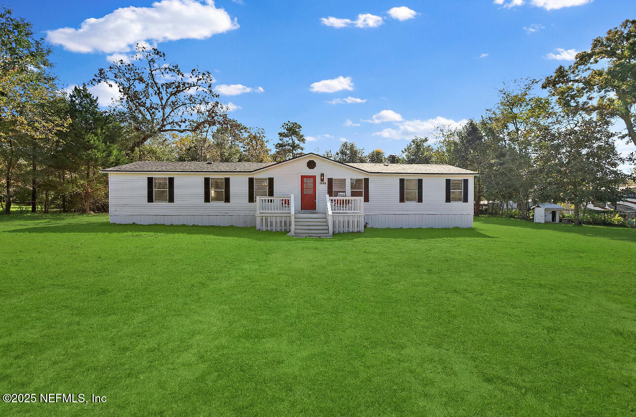 86090 Jean Road Yulee, FL 32097 - Photo 1 of 22 a front view of house with yard and green space