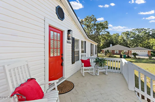 a balcony with furniture and a potted plant