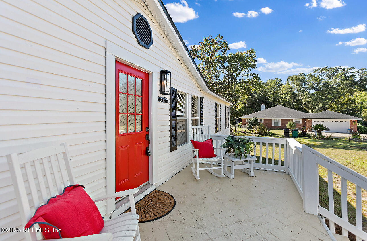 86090 Jean Road Yulee, FL 32097 - Photo 2 of 22 a balcony with furniture and a potted plant
