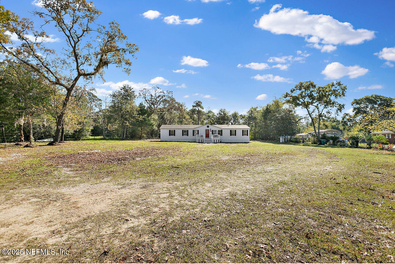 86090 Jean Road Yulee, FL 32097 - Photo 22 of 22 a view of outdoor space with garden and trees