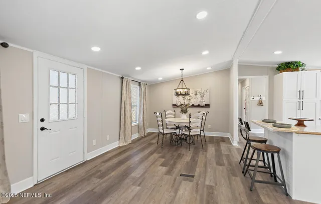 a view of a dining room with furniture and wooden floor