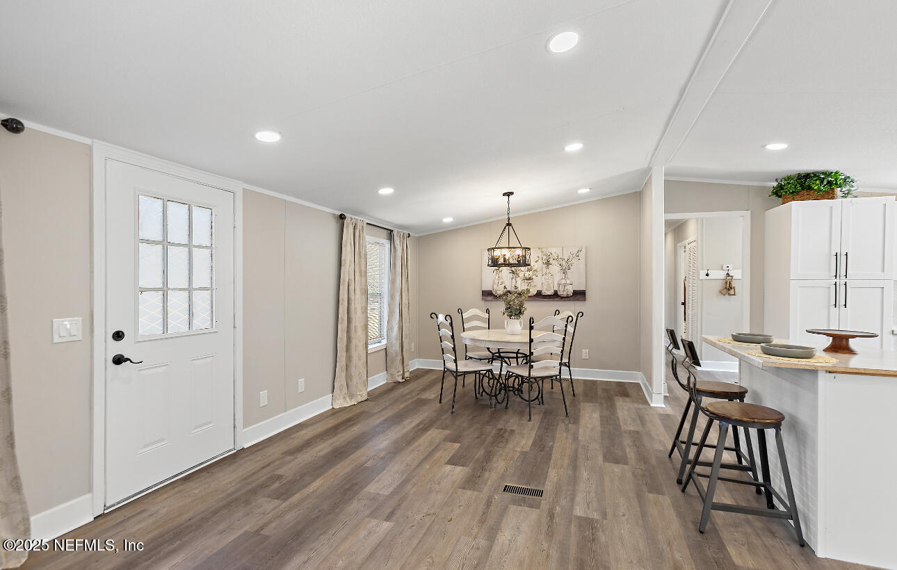 86090 Jean Road Yulee, FL 32097 - Photo 3 of 22 a view of a dining room with furniture and wooden floor