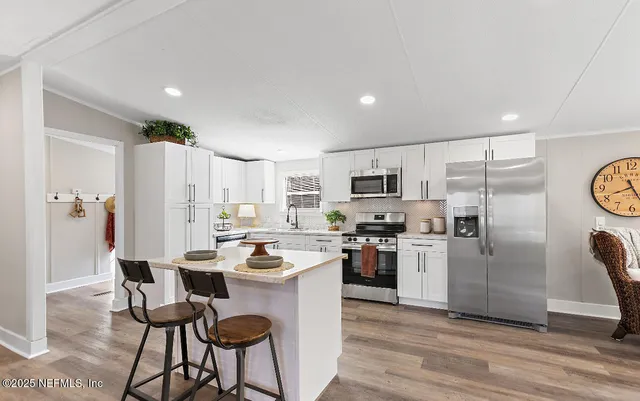 a kitchen with refrigerator and cabinets