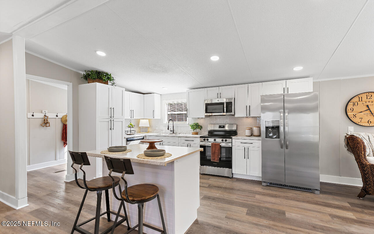 86090 Jean Road Yulee, FL 32097 - Photo 5 of 22 a kitchen with refrigerator and cabinets