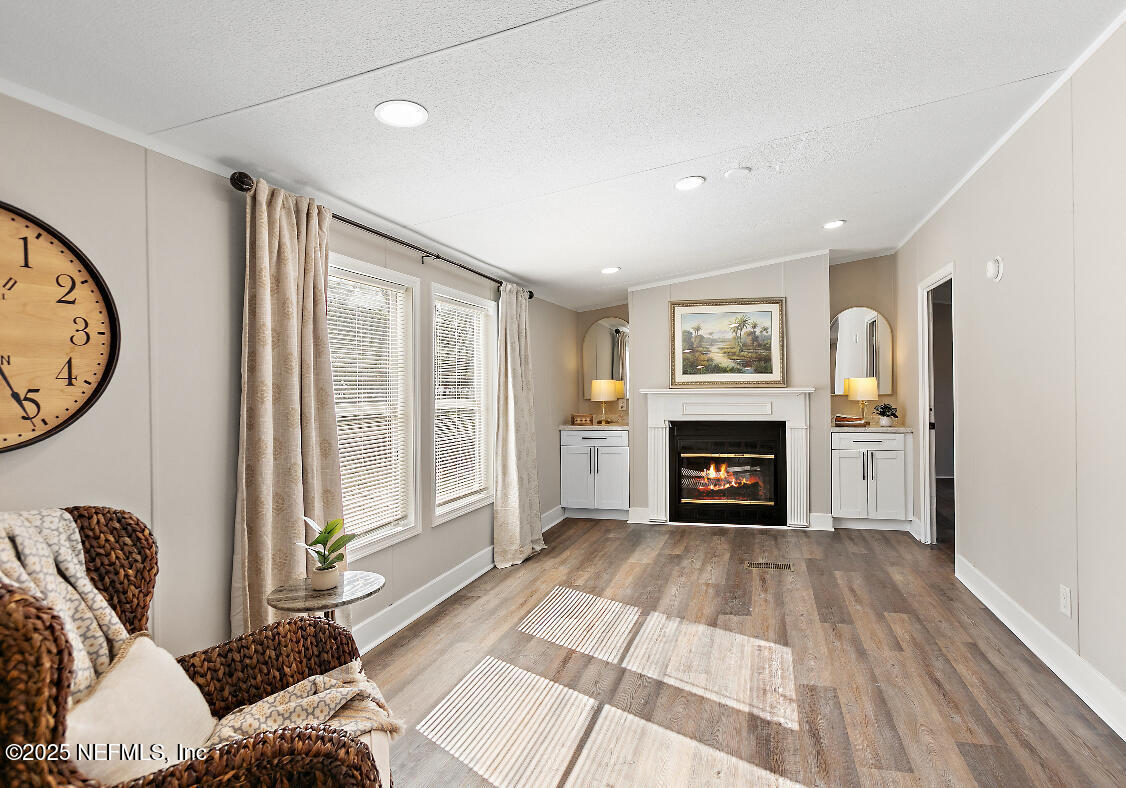 86090 Jean Road Yulee, FL 32097 - Photo 8 of 22 a living room with furniture a fireplace and a large window
