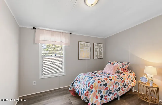 a bedroom with a bed and a window