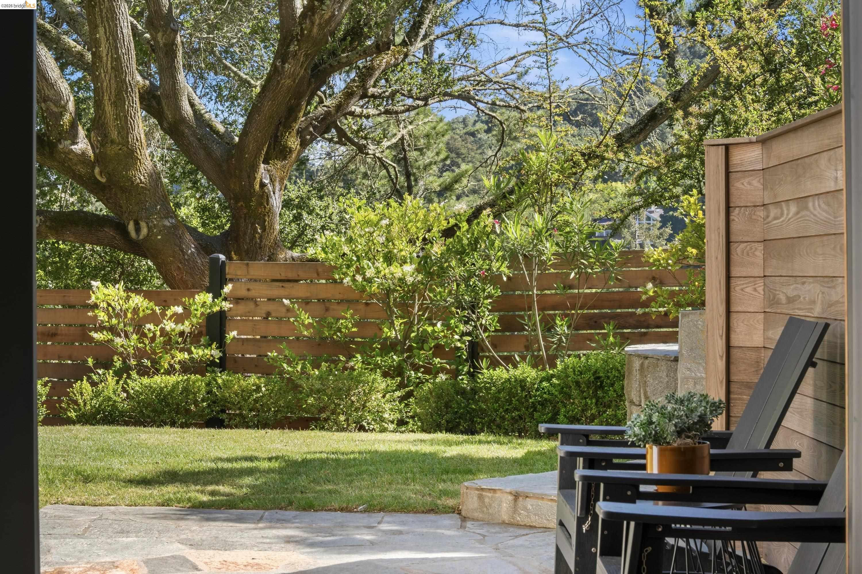 4120 Happy Valley Road Lafayette, CA 94549 - Photo 42 of 48 Stone patio area featuring a level lawn, mature tree, and horizontal wood fencing