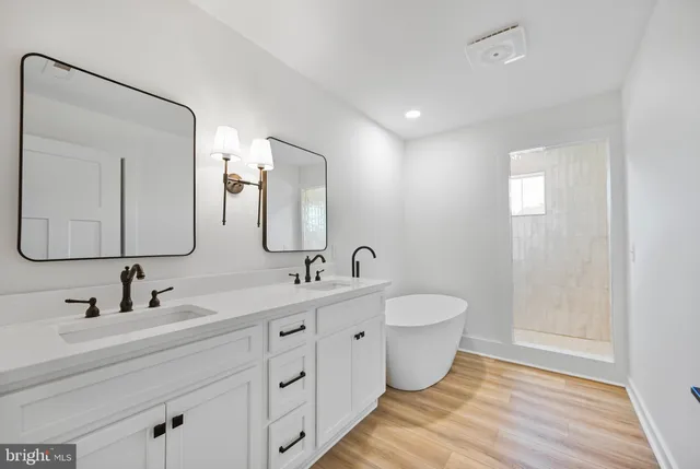 a spacious bathroom with a double vanity sink mirror and