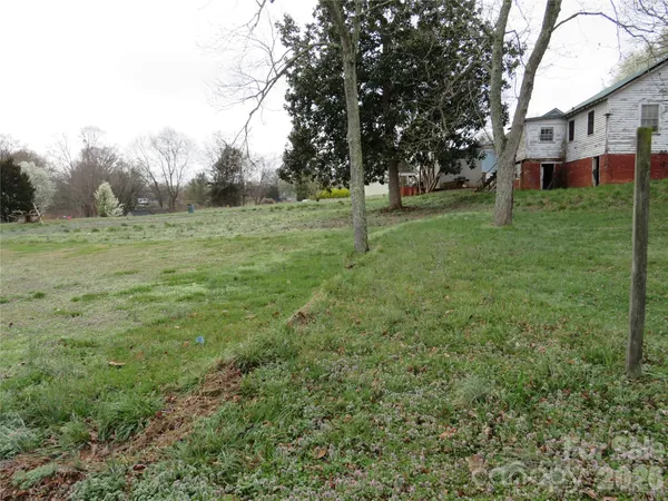 a view of a field with trees