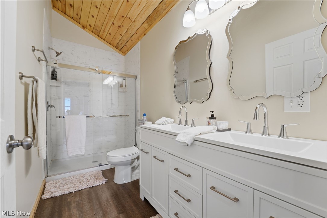 5919 Lake Road West, Unit 32 Ashtabula, OH 44004 - Photo 17 of 23 Full bath with a marble finish shower, double vanity, a vaulted wood ceiling, and dark wood-type flooring