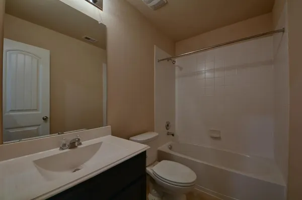 a bathroom with a sink toilet vanity and shower