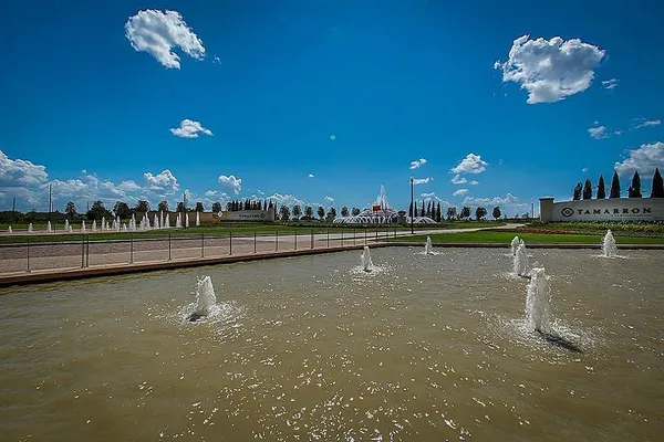 a view of a swimming pool and a yard
