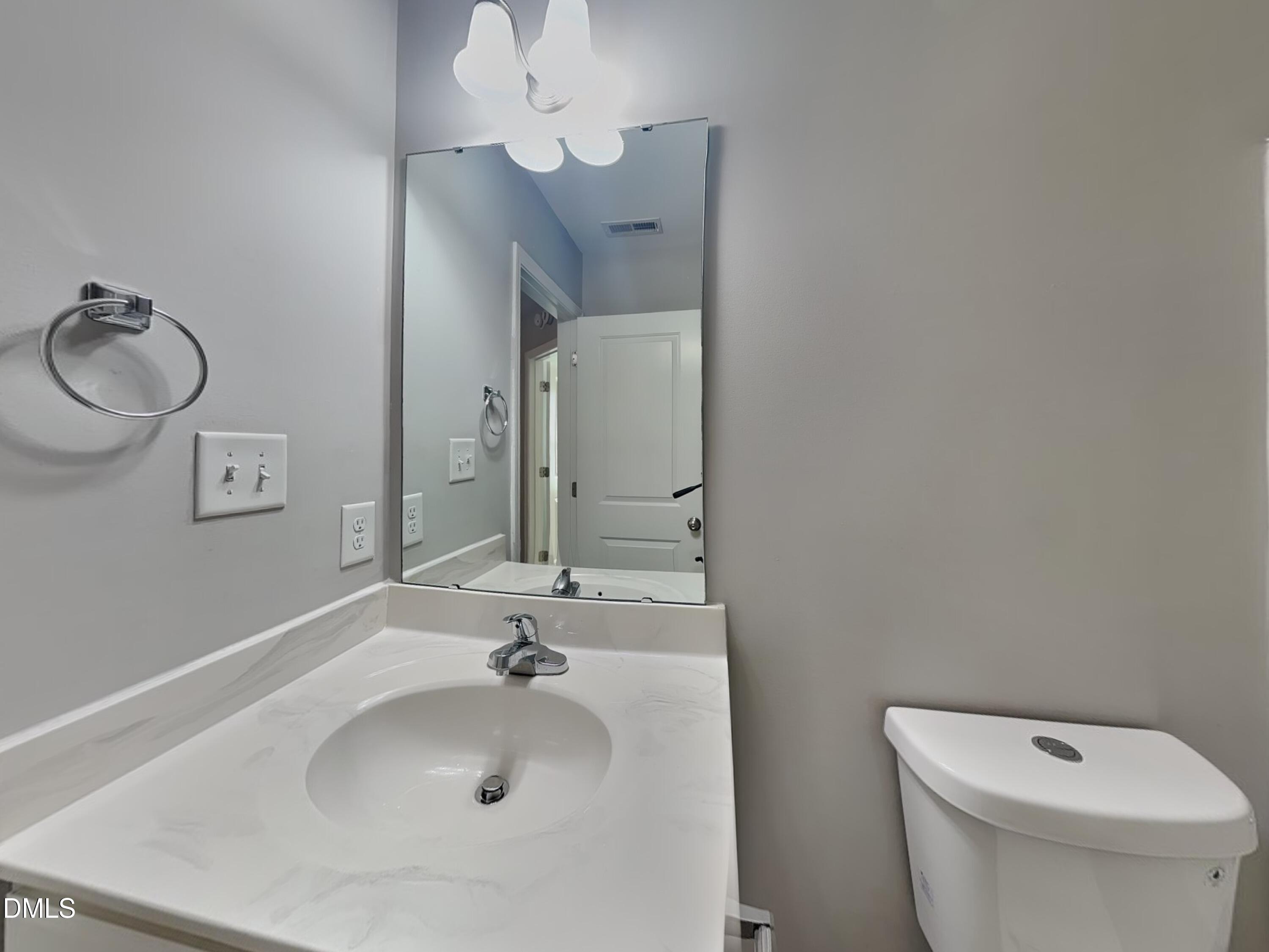 147 Cattail Lane Zebulon, NC 27597 - Photo 14 of 15 a bathroom with a toilet sink and mirror