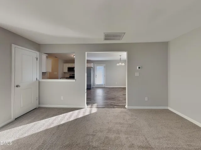 a view of a big room with wooden cabinet and windows