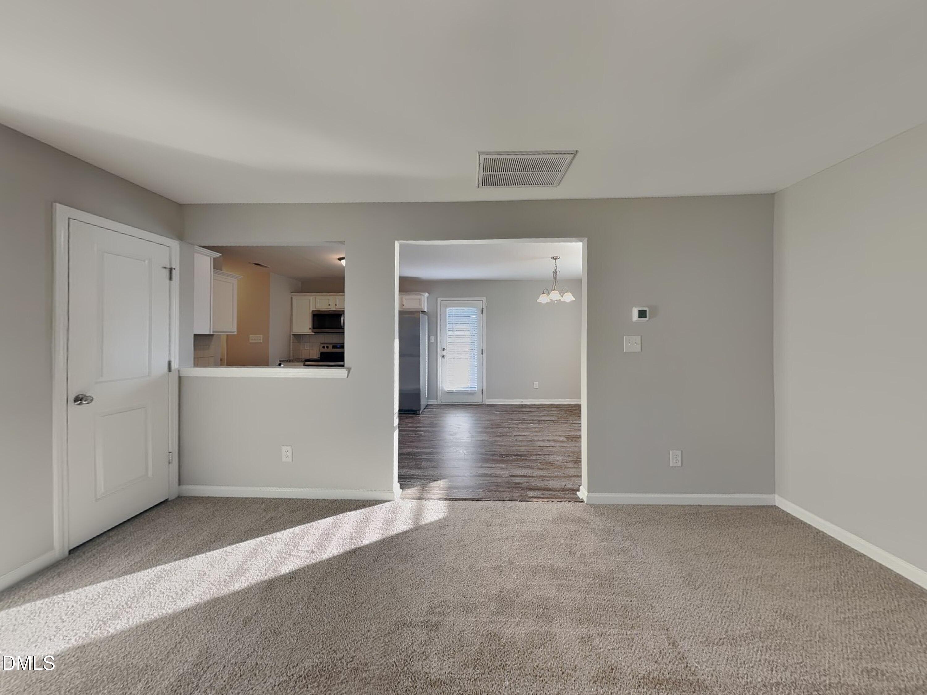147 Cattail Lane Zebulon, NC 27597 - Photo 2 of 15 a view of a big room with wooden cabinet and windows