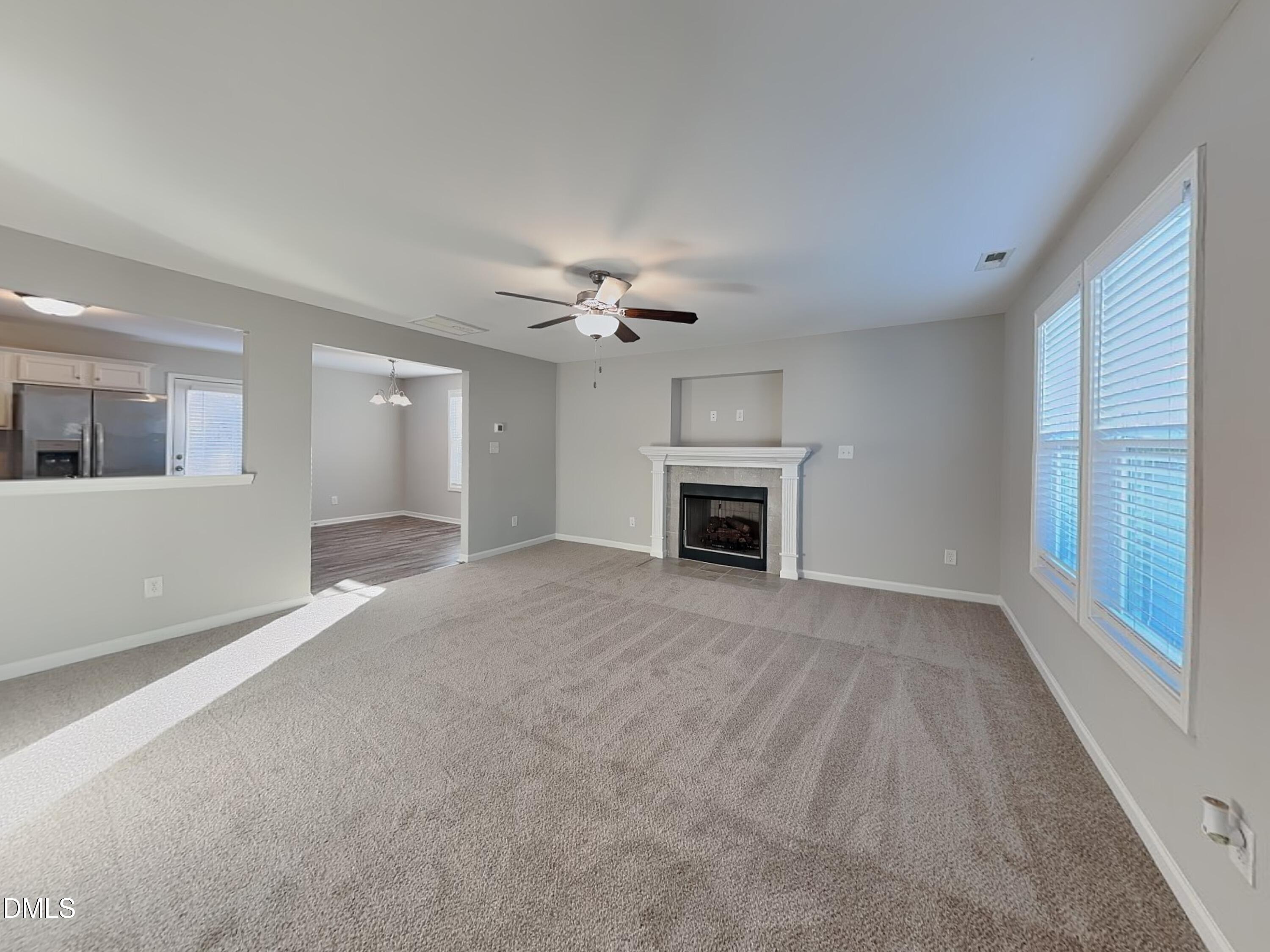 147 Cattail Lane Zebulon, NC 27597 - Photo 3 of 15 a view of an empty room with a fireplace and a window