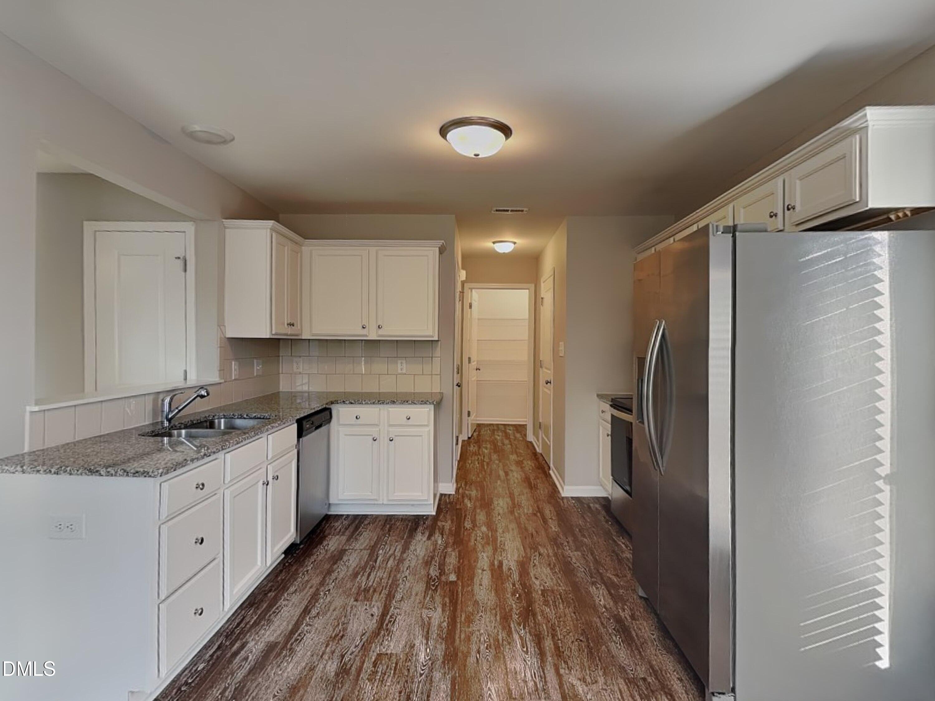 147 Cattail Lane Zebulon, NC 27597 - Photo 5 of 15 a kitchen with a refrigerator and a sink