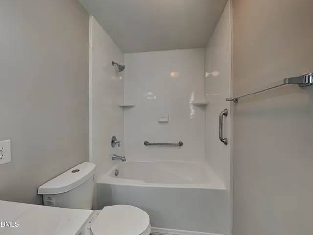 a bathroom with a toilet and a bathtub