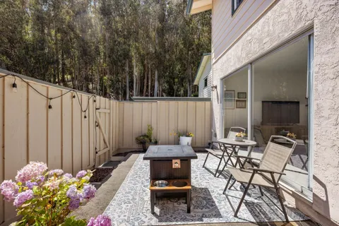 a table and chair sitting in front of a house