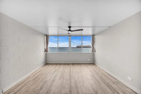 a view of a kitchen with wooden floor and a sink