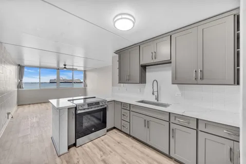 a kitchen with cabinets stainless steel appliances and sink