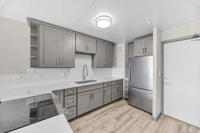 a kitchen with stainless steel appliances a refrigerator and a sink
