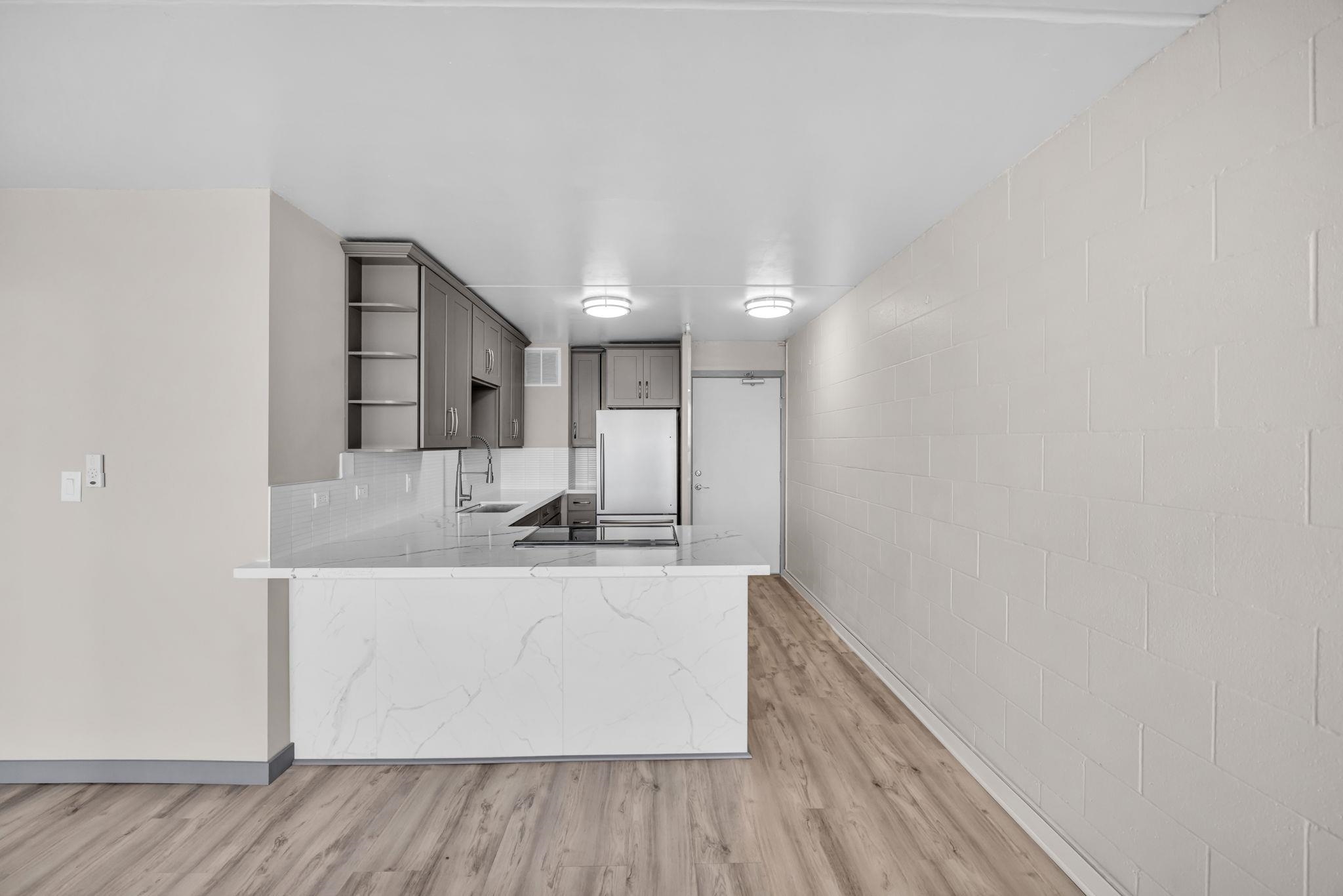 111 Kahului Beach Road, Unit A310 Kahului, HI 96732 - Photo 7 of 35 a view of a kitchen with a sink and dishwasher with wooden floor
