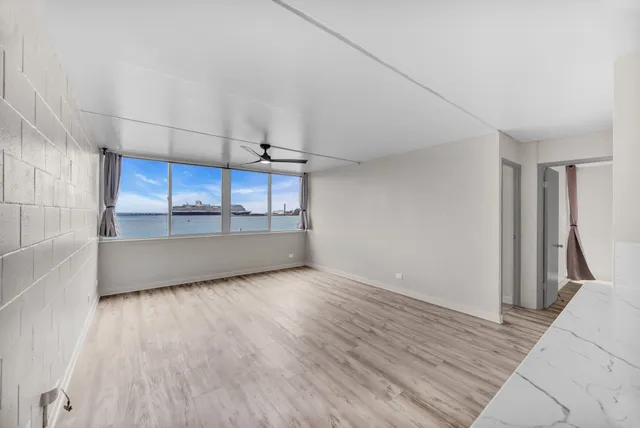 a view of a kitchen with a sink and wooden floor