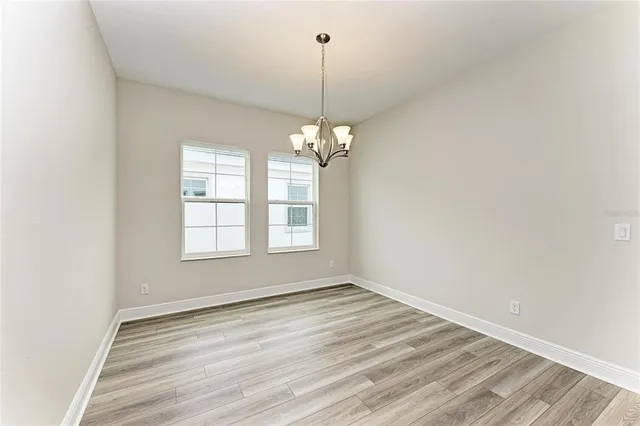 a view of a room with windows and chandelier