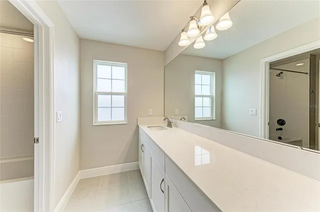 a bathroom with a tub sink and mirror